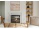 Modern fireplace with white stone surround and floating shelves with decor at 38 Mildred Nw Pl, Atlanta, GA 30318