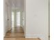 Hallway featuring wood floors, white trim, and multiple doors with hardware at 38 Mildred Nw Pl, Atlanta, GA 30318