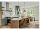 An open-concept kitchen features an island, a dining table, and stainless appliances at 38 Mildred Nw Pl, Atlanta, GA 30318