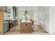 Bright kitchen with stainless appliances, a large island and designer light fixtures at 38 Mildred Nw Pl, Atlanta, GA 30318
