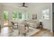 Sunlit living room with neutral-toned furniture, wood floors, and large windows overlooking the backyard at 38 Mildred Nw Pl, Atlanta, GA 30318