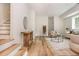 Open-concept living room with hardwood floors, stylish furnishings, and staircase leading to upstairs at 38 Mildred Nw Pl, Atlanta, GA 30318