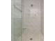 Elegant shower with white marble-like tiles and glass door offers a luxurious bathing experience at 38 Mildred Nw Pl, Atlanta, GA 30318