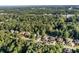 Expansive aerial view of a residential neighborhood surrounded by lush green forest and mature trees at 660 Briarleigh Way, Woodstock, GA 30189