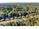 Expansive aerial view of a residential area surrounded by lush trees and green landscape at 660 Briarleigh Way, Woodstock, GA 30189