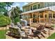 Inviting backyard with stone patio, fire pit, and covered deck, perfect for outdoor entertaining at 660 Briarleigh Way, Woodstock, GA 30189