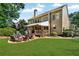 Expansive backyard with a patio area, firepit, and lush greenery at 660 Briarleigh Way, Woodstock, GA 30189