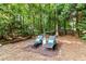 Secluded backyard area with lounge chairs and lush greenery, ideal for relaxation at 660 Briarleigh Way, Woodstock, GA 30189