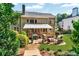 Well-maintained backyard featuring stone patio, fire pit, covered deck, and manicured landscaping at 660 Briarleigh Way, Woodstock, GA 30189