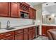 Bar area with granite counters, cabinetry, and beverage cooler at 660 Briarleigh Way, Woodstock, GA 30189