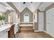 Bathroom featuring a large soaking tub with tile surround, and a vanity area at 660 Briarleigh Way, Woodstock, GA 30189