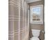 Neutral tones bathroom with a fabric shower curtain and natural light at 660 Briarleigh Way, Woodstock, GA 30189