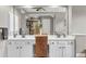 Bathroom featuring dual vanity sinks with white cabinets and a large mirror reflecting the room at 660 Briarleigh Way, Woodstock, GA 30189