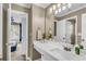 Bright bathroom with a white countertop vanity, large mirror and natural light at 660 Briarleigh Way, Woodstock, GA 30189