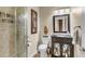Bathroom featuring walk-in shower with glass door, dark vanity with mirror, and toilet at 660 Briarleigh Way, Woodstock, GA 30189