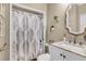 Cozy bathroom with neutral tones, granite countertop, framed mirror and decorative shower curtain at 660 Briarleigh Way, Woodstock, GA 30189