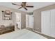 Neutral bedroom featuring ceiling fan, walk-in closet, and access to an en-suite bathroom at 660 Briarleigh Way, Woodstock, GA 30189