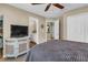 Bedroom with a queen bed, TV on a dresser, ceiling fan, and view to adjacent rooms at 660 Briarleigh Way, Woodstock, GA 30189