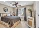 Bedroom features a queen bed, decorative mirror, ceiling fan and small window with blinds at 660 Briarleigh Way, Woodstock, GA 30189