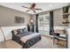 Cozy bedroom featuring a ceiling fan, dark-colored furniture, and natural light at 660 Briarleigh Way, Woodstock, GA 30189