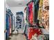 Walk-in closet with metal rack shelving, and an assortment of clothing, suitcases, and bags at 660 Briarleigh Way, Woodstock, GA 30189