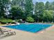 Community pool with slide, lounge chairs, and umbrella tables provides a refreshing and relaxing experience at 660 Briarleigh Way, Woodstock, GA 30189