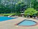 Community pool with water slide and seating areas offers a refreshing escape, creating a social and recreational space at 660 Briarleigh Way, Woodstock, GA 30189