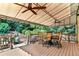 Covered outdoor deck with dining area and views of the landscaped backyard at 660 Briarleigh Way, Woodstock, GA 30189