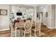 Dining room with rustic wood table adjacent to living room with fireplace and built-in shelving at 660 Briarleigh Way, Woodstock, GA 30189