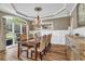 Dining room features wood floors, large windows, and elegant decor, perfect for gatherings at 660 Briarleigh Way, Woodstock, GA 30189