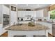 Spacious kitchen with white cabinets, granite countertops, and a central island, perfect for cooking at 660 Briarleigh Way, Woodstock, GA 30189