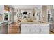 Kitchen island with granite counters connects to a dining area and stainless steel appliances at 660 Briarleigh Way, Woodstock, GA 30189
