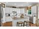 Bright kitchen featuring white cabinets, granite countertops, a center island with seating, and stainless steel appliances at 660 Briarleigh Way, Woodstock, GA 30189
