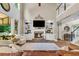 Living room with fireplace, built-in bookshelves, and view to second floor landing at 660 Briarleigh Way, Woodstock, GA 30189