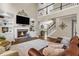Bright living room featuring a stone fireplace, large windows, and comfortable seating at 660 Briarleigh Way, Woodstock, GA 30189
