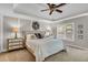 Serene main bedroom with tray ceilings, stylish décor, and lots of natural light at 660 Briarleigh Way, Woodstock, GA 30189