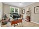 A cozy home office featuring a window, a desk, and carpeted flooring at 660 Briarleigh Way, Woodstock, GA 30189