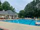 Inviting community pool with lounge chairs and umbrellas, perfect for relaxation and socializing at 660 Briarleigh Way, Woodstock, GA 30189