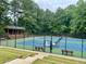 Well-maintained community tennis courts surrounded by lush greenery, providing a scenic and active recreational space at 660 Briarleigh Way, Woodstock, GA 30189