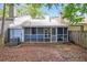 Backyard featuring a screened-in porch, mature trees and landscaping at 937 Ohara Drive Dr, Jonesboro, GA 30236