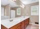 Spacious bathroom with double vanity sinks and an extra-large mirror, and tile flooring at 1574 Glenfield Dr, Lawrenceville, GA 30043