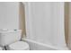Cozy bathroom featuring a shower tub combination and a standard white toilet at 1574 Glenfield Dr, Lawrenceville, GA 30043