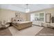Primary bedroom showcasing a large bed, a dresser, and an accent chair near the window at 1574 Glenfield Dr, Lawrenceville, GA 30043