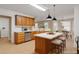 Eat-in kitchen with stainless steel appliances, light countertops and warm wood cabinets at 1574 Glenfield Dr, Lawrenceville, GA 30043