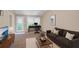 Cozy living room with a desk, couch, and TV, perfect for relaxing or working at 1574 Glenfield Dr, Lawrenceville, GA 30043