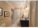 Bathroom with decorative mirror and lights, marble counter and built in closet at 1620 Silverleaf Way, Alpharetta, GA 30005