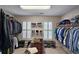 Walk-in closet providing ample storage and organization, with custom shelving and hanging racks at 1620 Silverleaf Way, Alpharetta, GA 30005