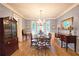 Formal dining room featuring a chandelier, hardwood floors, and large windows, perfect for Gathering gatherings at 1620 Silverleaf Way, Alpharetta, GA 30005