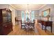 Formal dining room featuring hardwood floors, chandelier, and large windows at 1620 Silverleaf Way, Alpharetta, GA 30005