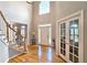 Bright foyer featuring a grand staircase, gleaming hardwood floors, and a high ceiling with a large window at 1620 Silverleaf Way, Alpharetta, GA 30005